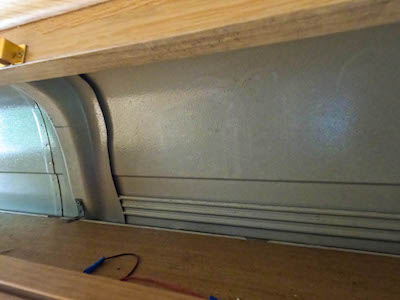 Top cupboard with exposed skin of the van