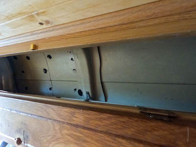 Top cupboard with exposed skin of the van