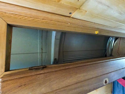 Top cupboard with exposed skin of the van